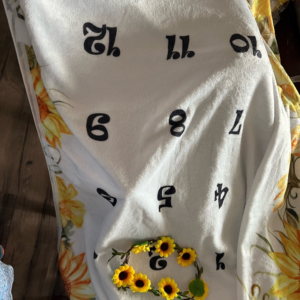 White Towel with Black Numbers and Sunflower Design